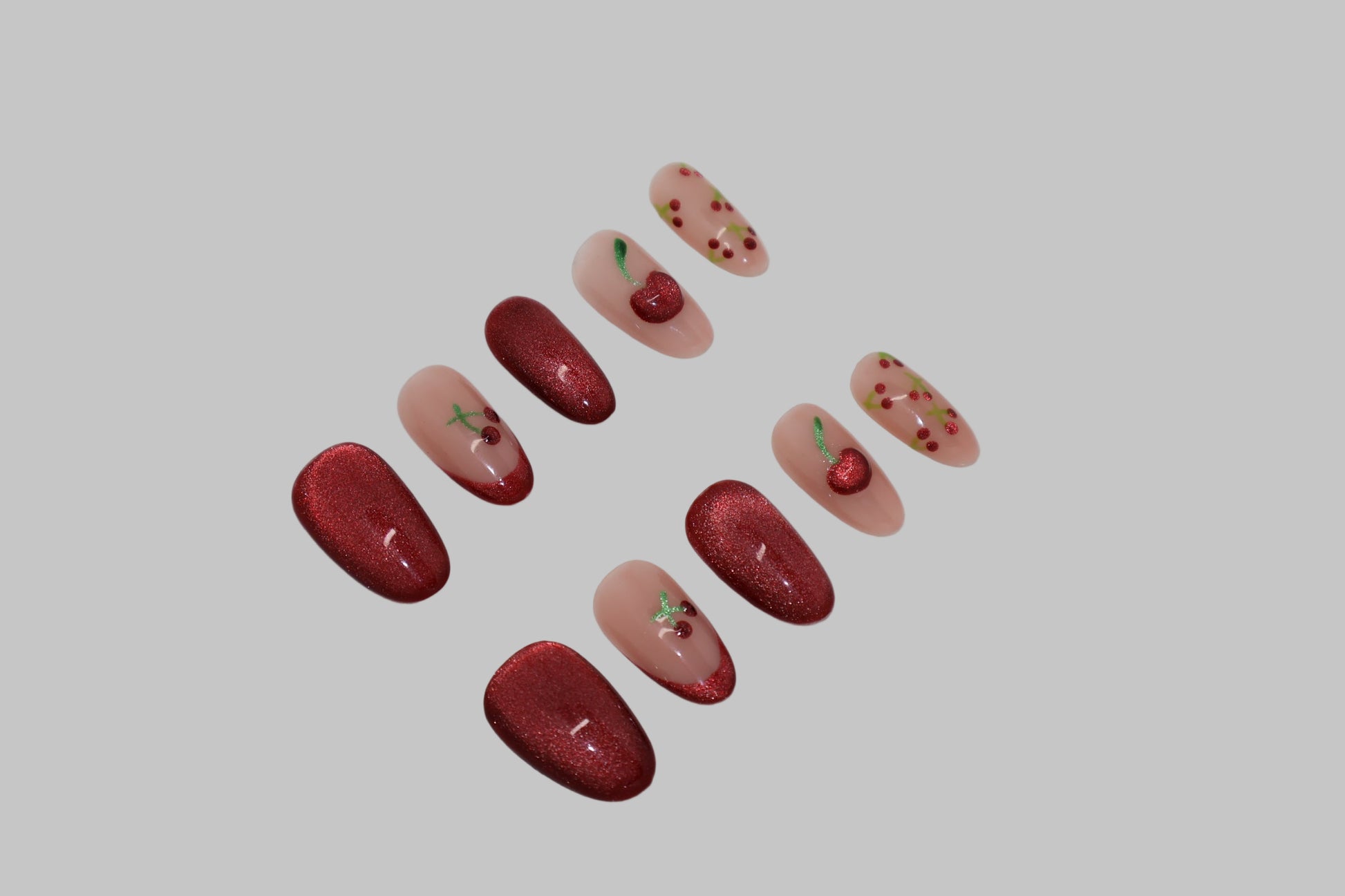 Set of cherry red cat eye nails on white background