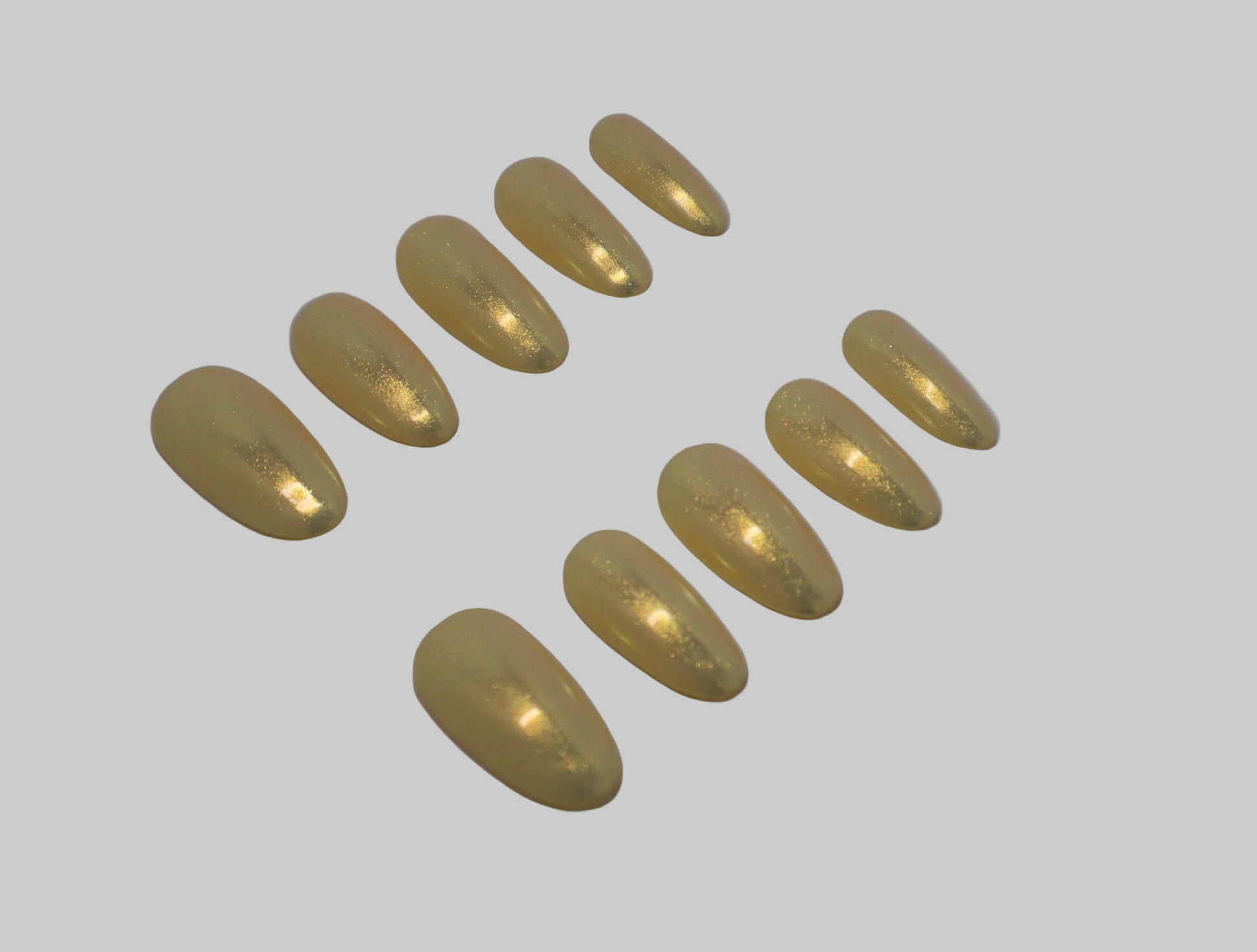 Set of Iridescent gold nails on white background