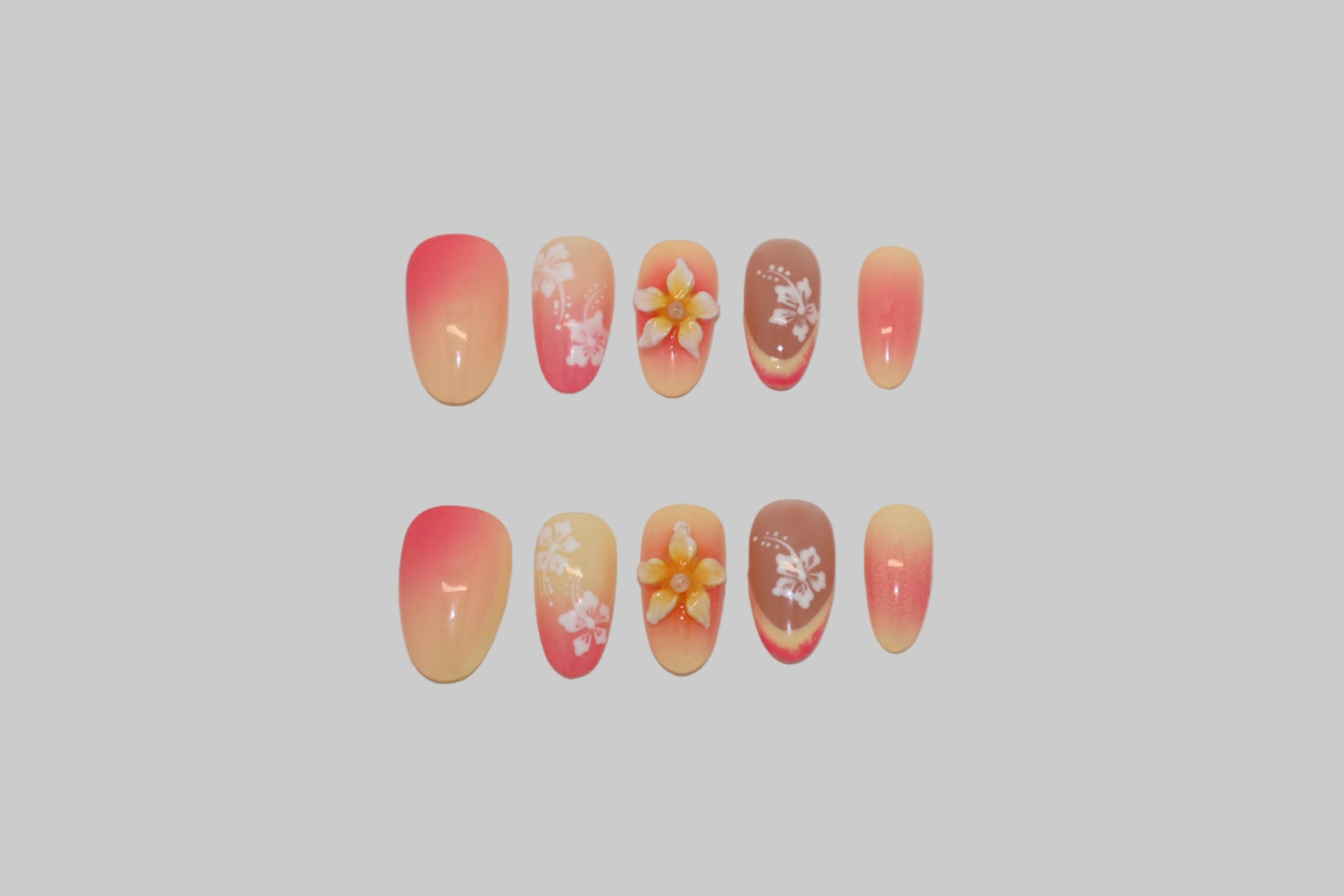 Set of nails with 3D floral designs on a white background