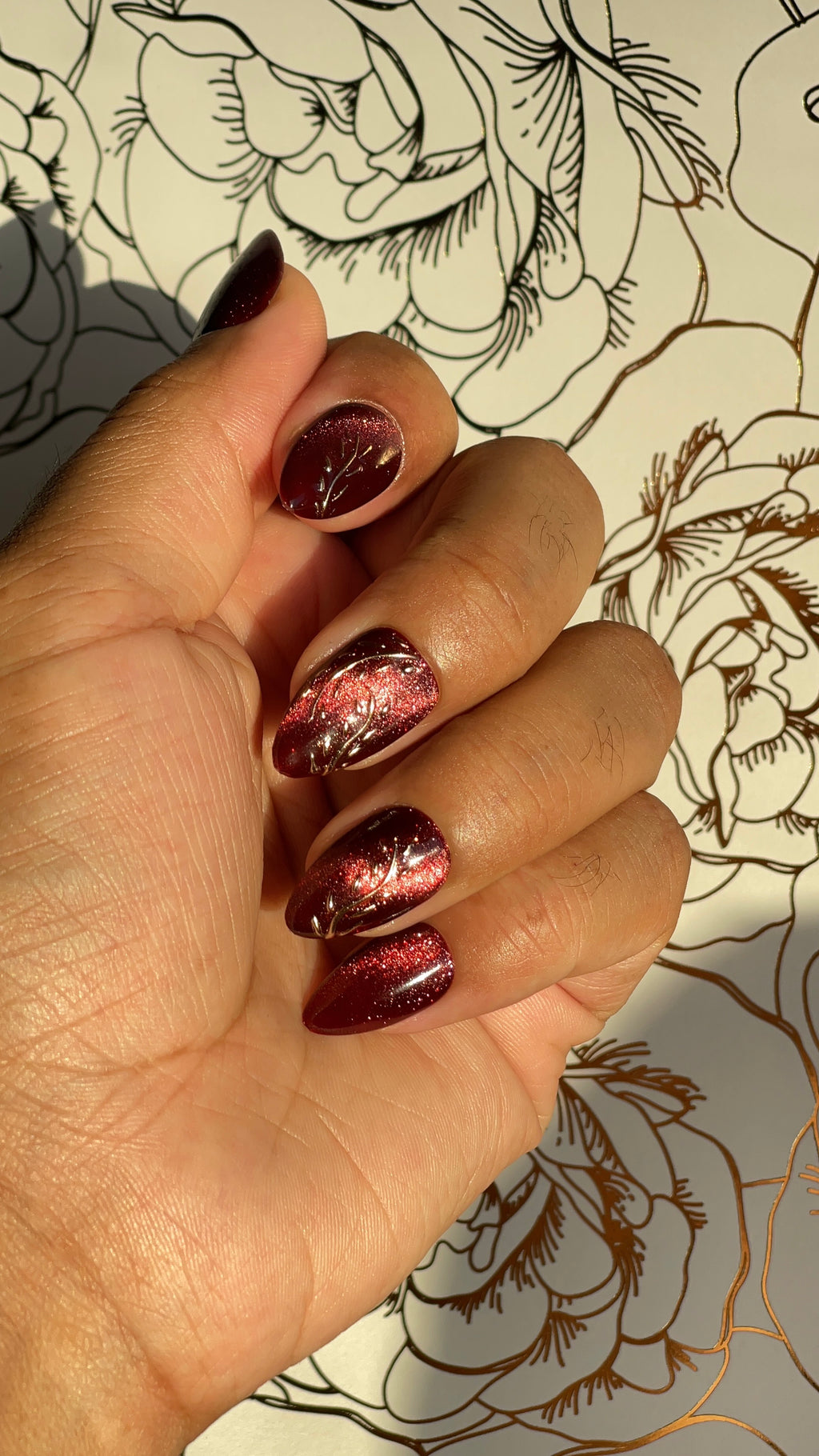 Deep red Cat eye press-on nails with golden accents. Inspired by glowing embers and winter warmth — for bold, grounded beauty.