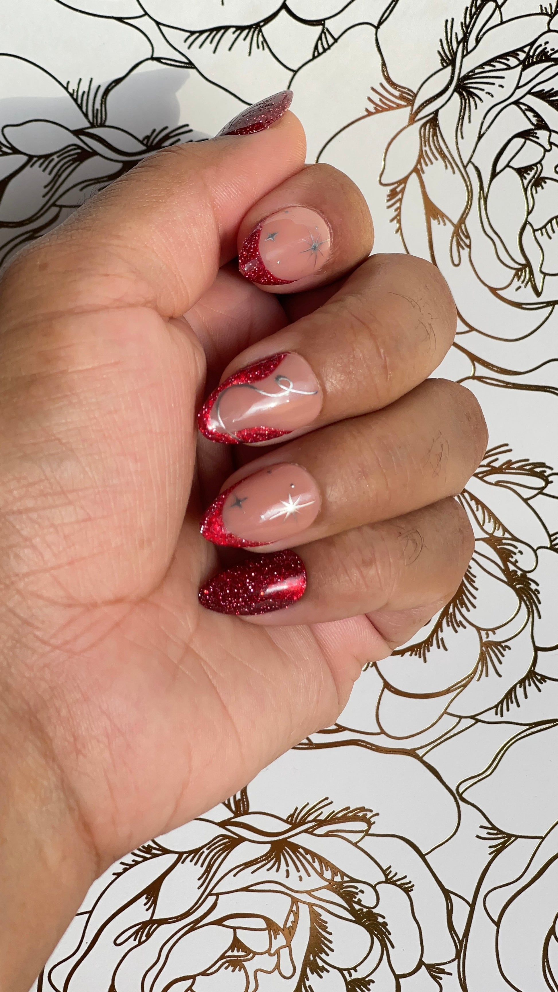 Red glitter press-on nails with nude contrast and starlit accents. A graceful yet bold design that flows like snowdrift in motion.