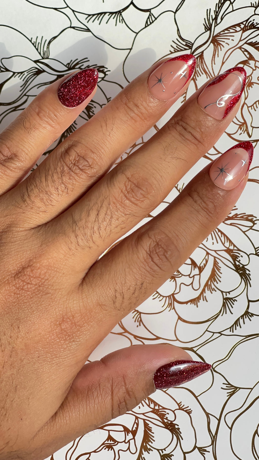 Red glitter press-on nails with nude contrast and starlit accents. A graceful yet bold design that flows like snowdrift in motion.