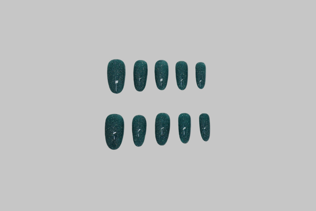 Teal glitter nails on white background
