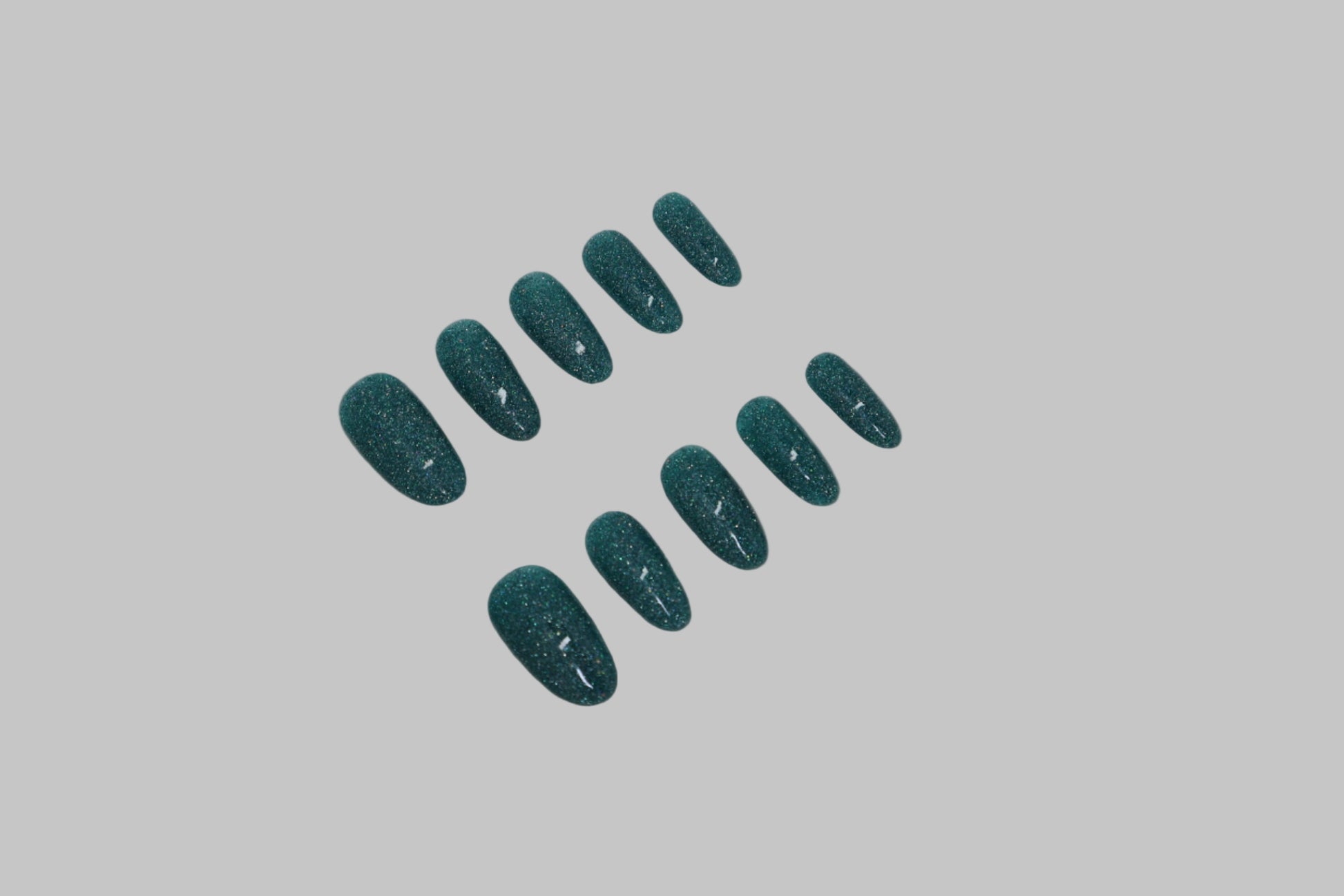 Teal glitter nails on a white background